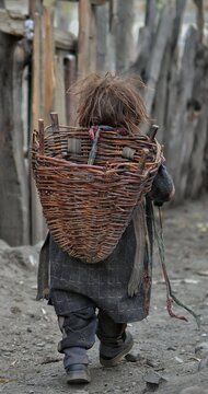 Child Carrying A Wicker Basket