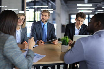 Business meeting - manager discussing work with his colleagues.
