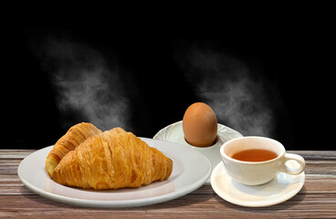 fresh butter croissant on plate and cup of coffee with boiled egg on bowl with light bokeh for healthy