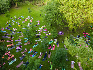 overhead view of people do yoga at city public park