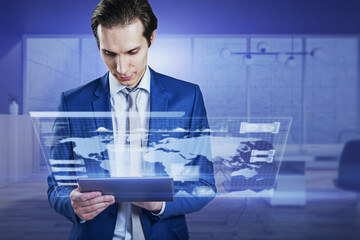 Attractive young european businessman using tablet with creative blue radar map interface on blurry office interior background. Spy and hud concept. Double exposure.
