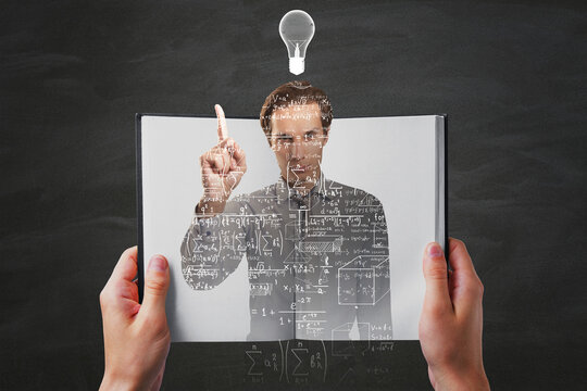Hands holding open notepad with abstract caucasian businessman outline filled with mathematical formulas on chalkboard wall backround with lamp. Science, idea and education concept. - Powered by Adobe