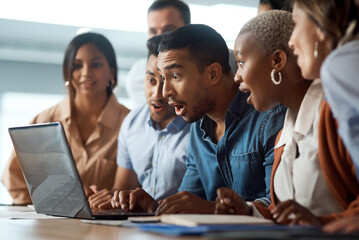 Dont be surprised when your dreams are finally realised. Shot of a group of young businesspeople using a laptop and looking shocked in a modern office.