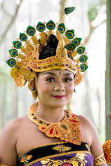 Balinese dancer woman outdoors forest with colorful bird costume