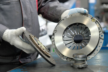 Spare parts for cars. Car clutch kit. An auto mechanic monitors the compliance and integrity of the...