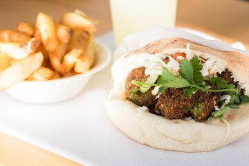 Falafel in pita bread with fries 
