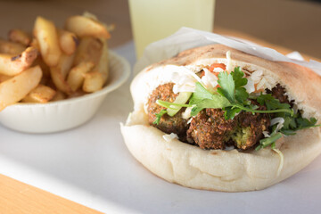 Falafel in pita bread with fries 
