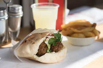 Falafel in pita bread with fries 
