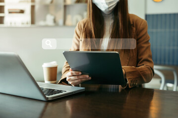 Woman uses a tablet to search for information in the home in the morning.