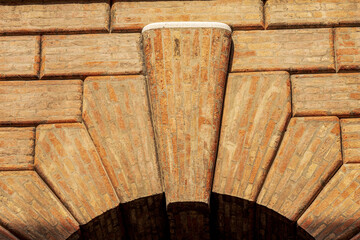 Close-up of a medieval arch made of bricks with keystone with the rusticated wall or ashlar (Bugnato in Italian), in Treviso downtown, Veneto, Italy, Europe.