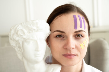 Portrait of young woman with lifting treatment on face. Face and body taping. A special cosmetic procedure for the skin.