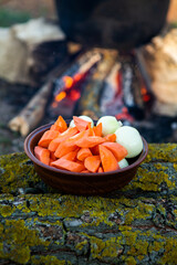 Fish soup prepared over an open fire. Cooking fish soup over an open fire in a kettle. Cooking in hiking tourism and fishing