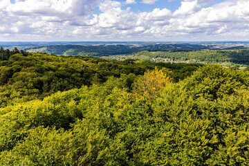 Fototapeta na wymiar Panorama of summer forest hills and lake valleys of Kashubian landscape park seen from Wiezyca hill observation tower near Szymbark town in Pomerania region of Poland