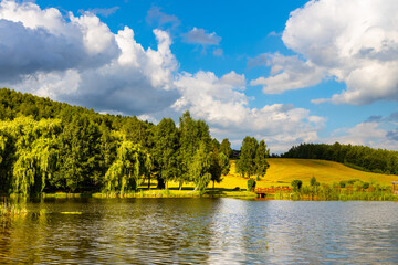 Panoramic view of Jezioro Wegleszynskie lake with wooded shores and surrounding hills in Ostrzyce village in Kashubia near Szymbark town in Pomerania region of Poland - obrazy, fototapety, plakaty