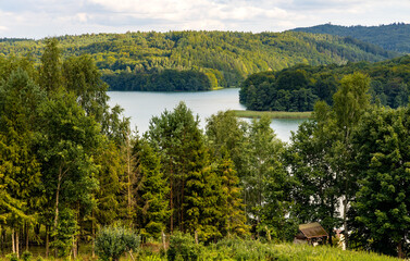 Panoramic view of Jezioro Ostrzyckie lake with shores of forest seen from Jastrzebia Gora Hawk Mountain in Ostrzyce village of Kashubia in Pomerania region of Poland