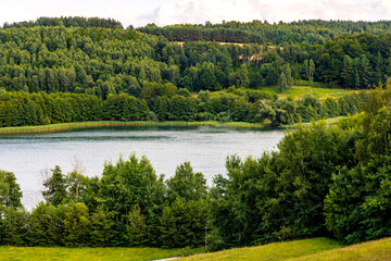 Panoramic view of Jezioro Brodno Wielkie lake with shores of forest and Sarnowka hill top seen from Zlota Gora Golden Mountain in Brodnica in Pomerania of Kashubian region of Poland - obrazy, fototapety, plakaty