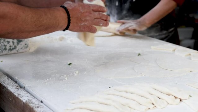 Women roll and cut dough, turkish cuisine, pastry dish, cooking traditional turkish food