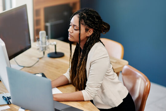 Working Hard To Get Her Company Off The Ground. High Angle Shot Of An Attractive Young Woman Working On A Computer In Her Home Office.