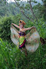 Portrait of Balinese dancer at outdoor in rainforest