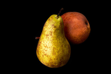 Red and green ripe pears on a black background. Healthy food. Vegan and vegetarian food