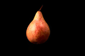 Juicy red pear on a black background. Vegan and vegetarian food