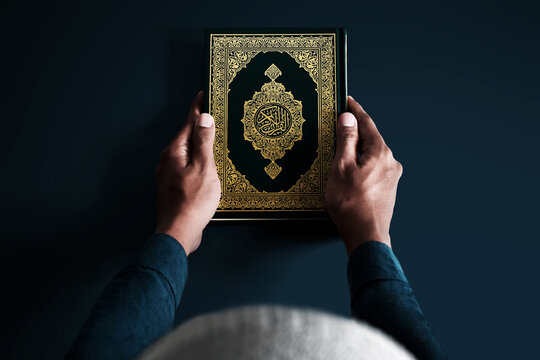 Muslim man holding holy quran