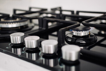 A gas cooker with regulators of level of a flame. The burner is light. The concept of kitchen...