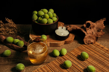 Ingredients for making Homemade plum wine or UMESHU on wooden table with black background.