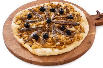 cooked pissaladière on a wooden board isolated on a white background