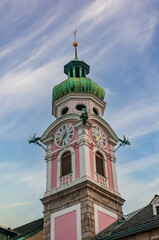 Tower of Hospital Church of the Holy Spirit against picturesque sky, Innsbruck, Austria
