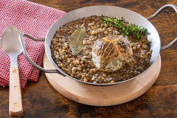 caillette cooked in a dish with lentils