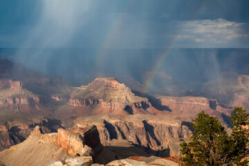 Grand Canyon with rain, rainbow and magnificent and dramatic sky