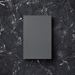 Photo of blank grey business card on black plaster background. Template for ID. Top view.