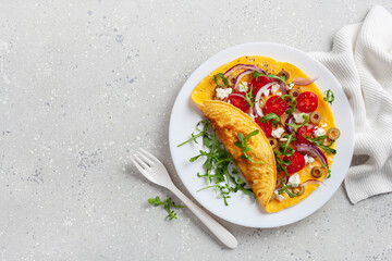 omelette with tomato, feta cheese onion and arugula. healthy keto diet low carb breakfast
