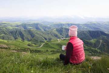 senior woman hiking in mountainous area. enjoy nature, have a good time. healthy lifestyle, leisure activity in old age. elderly travel