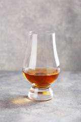 glass of whisky spirit brandy on gray concrete background