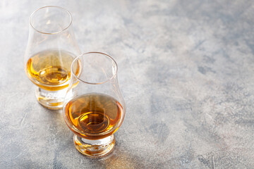 glass of whisky spirit brandy on gray concrete background