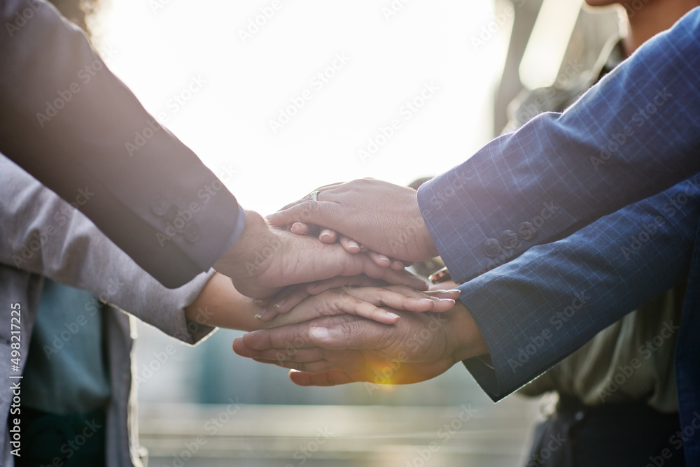 Poster Lets get this day started on a great note. Shot of a group of business people with their hands stacked together.