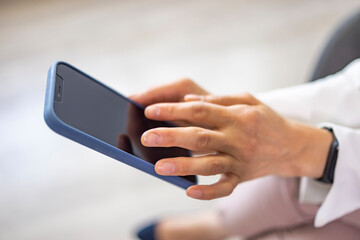 Surfing the net. Close up hand of business woman using smart phone with copy space. Woman work using cell phone hand holding mobile texting message contact us