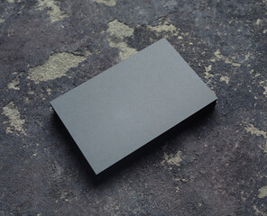 Photo of blank grey business cards on concrete background. Copy space for text.