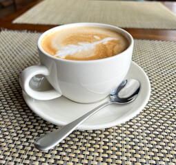 Cappuccino coffee in a cup and saucer 