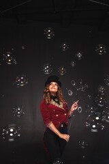 Female magician makes with soap bubbles show, an illusionist