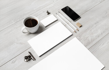 Photo of blank branding stationery template on light wooden background. Responsive design mockup.