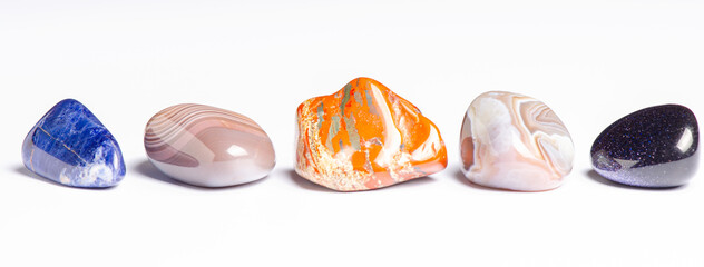 Mineral stones on a white background. The concept of using minerals in astrology and alternative or...