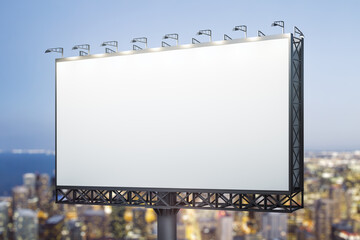 Blank white horizontal billboard on city buildings background at night, perspective view. Mockup, advertising concept