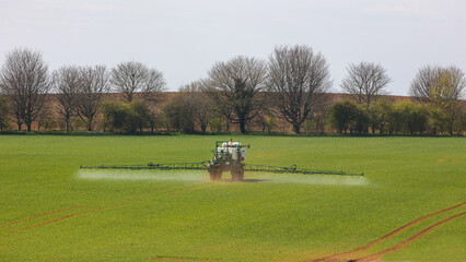 Crop sprayer at work in a field.
