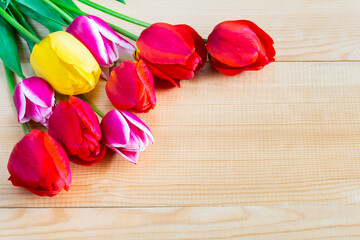 Bouquet of beautiful flowers of tulips on a wooden background