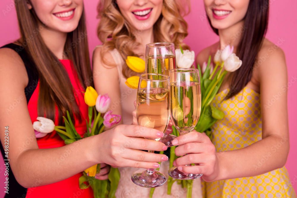 Wall mural Cropped photo of three positive ladies hold clink alcohol glass enjoy occasion isolated on pink color background