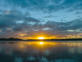 Fototapeta premium Sunrise and rain clouds waterscape