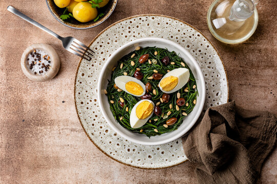 Dinner with Sauteed Agretti with Taggiasca olives, pinoli or pine nut, and boiled eggs.  Italian Salad. Boiled spring potato.. Top table view.
